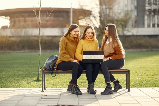 positive-girlfriends-using-laptop-on-bench-4172959.jpg