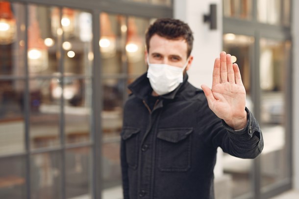 concerned-young-man-in-medical-mask-on-urban-street-during-3983404.jpg