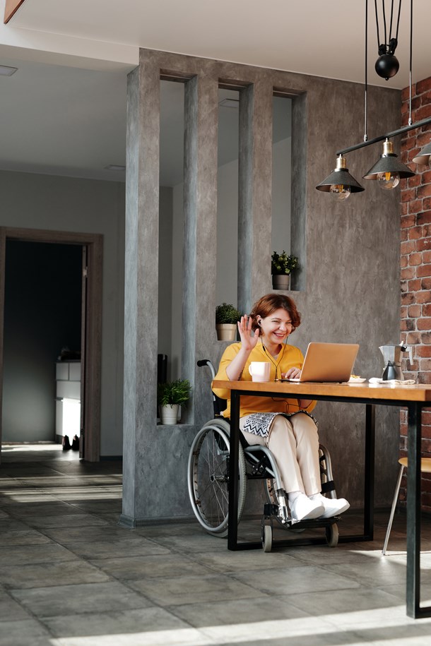 woman-in-orange-tank-top-sitting-on-black-wheelchair-4064696.jpg