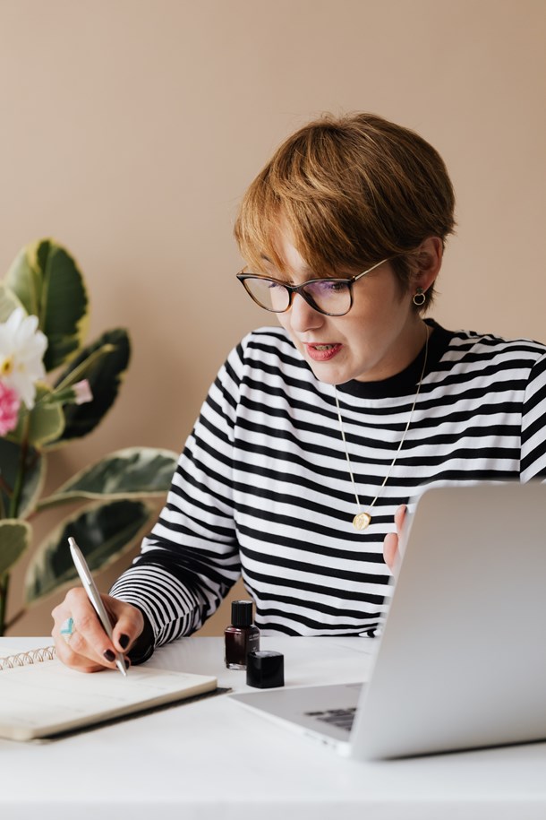 focused-woman-writing-notes-in-notebook-4467857.jpg